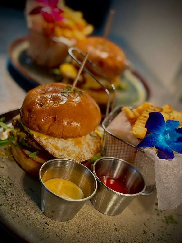Angus brunch burger plated with French fries at Sensaciones